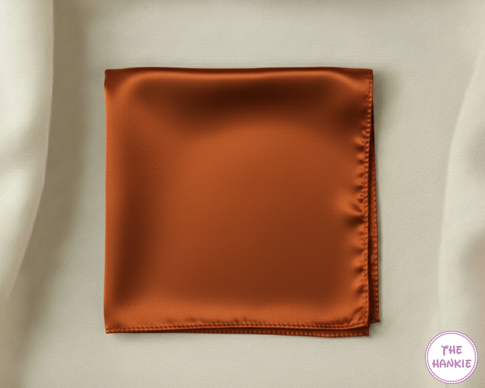 Brown satin hankie on a beige background with 'The Hankie' brand logo.