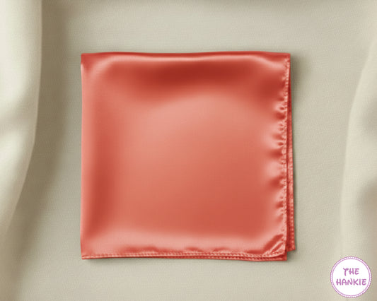 Red satin hankie on a beige fabric background with 'The Hankie' brand logo.