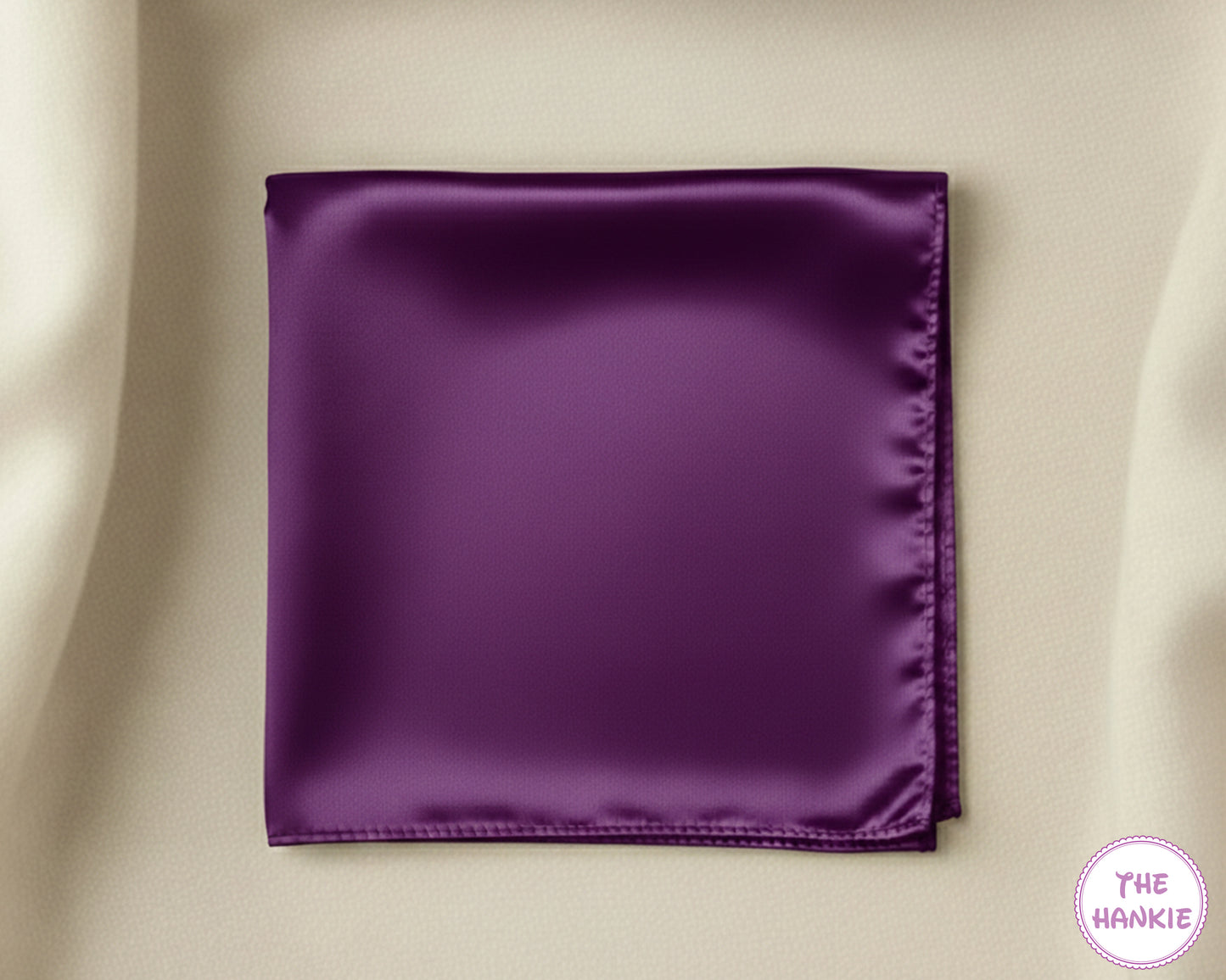 Purple satin pocket square on a beige background