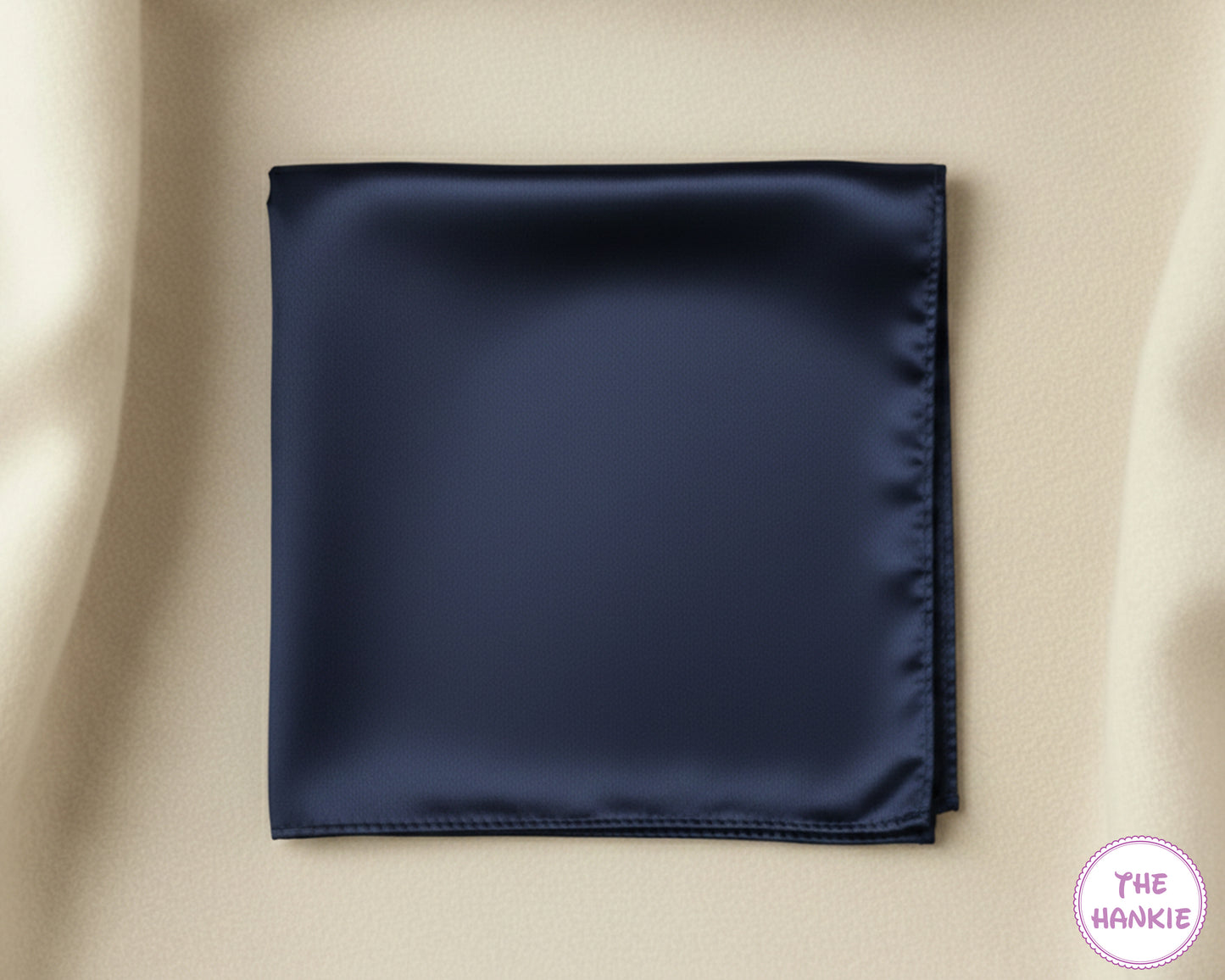 Navy blue satin hankie on a beige background with 'The Hankie' brand logo.