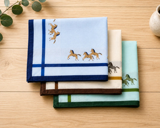 Set of folded handkerchiefs with plaid and striped patterns on a light surface.