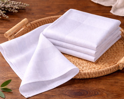 Stack of white napkin on a woven tray with a wooden background