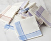 Stacks of plaid patterned hankies on a marble surface