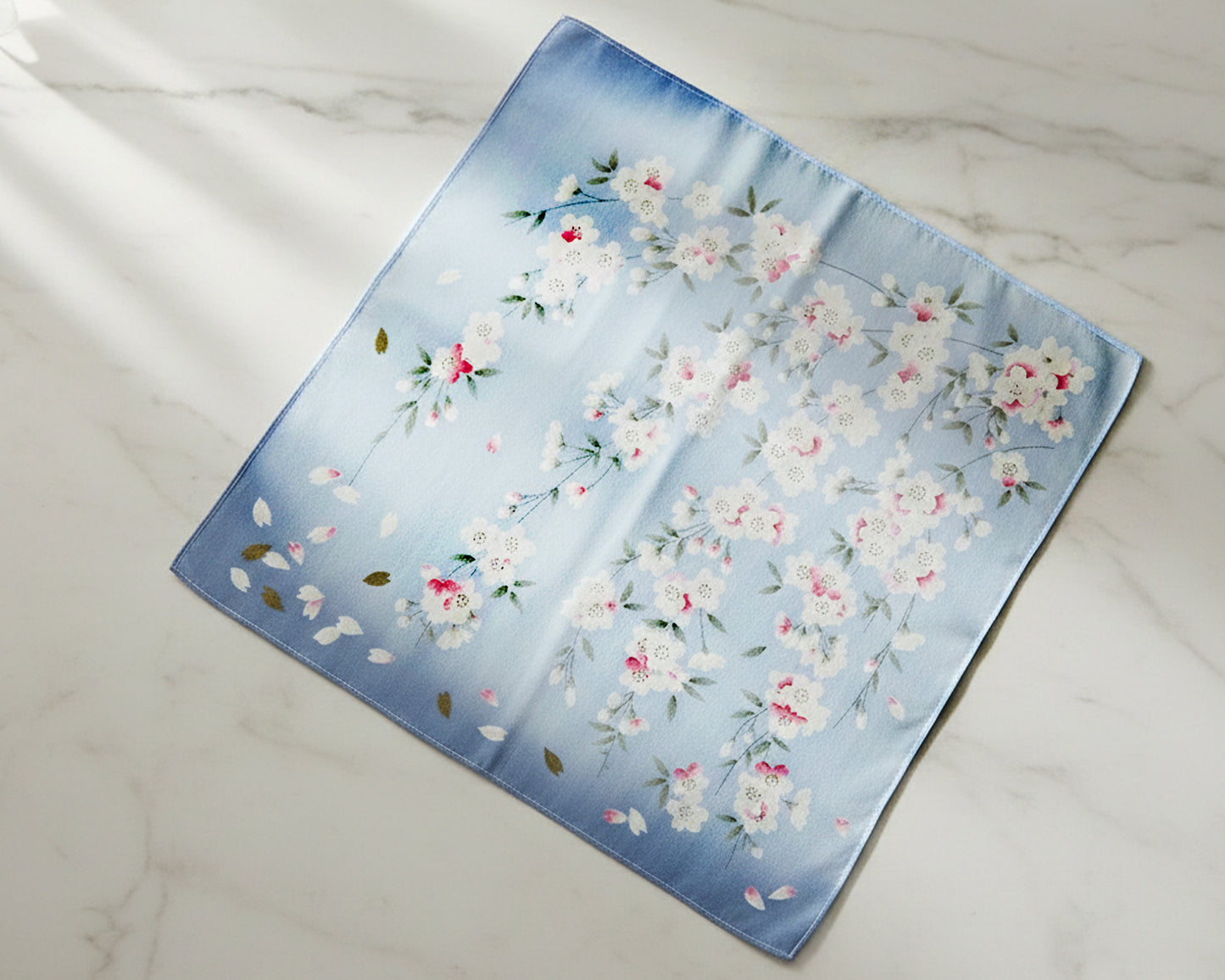 Floral patterned fabric handkerchief on a marble surface