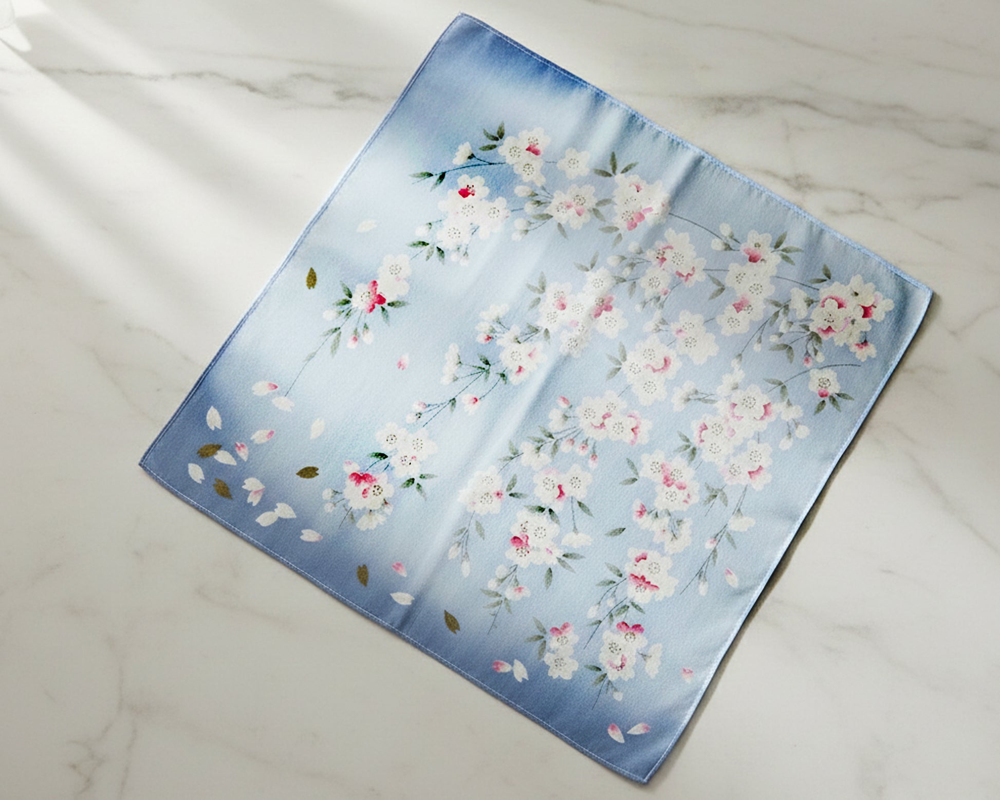 Floral patterned fabric handkerchief on a marble surface