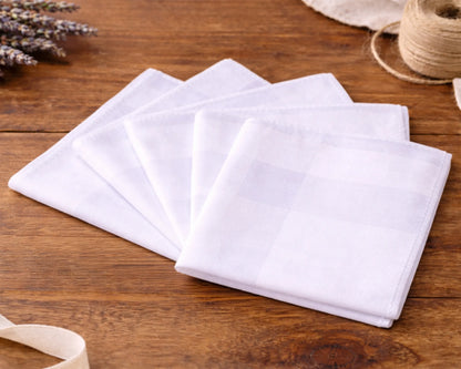 White fabric hanky on a wooden surface with lavender and twine in the background
