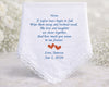 White handkerchief with embroidered text and hearts on a light background