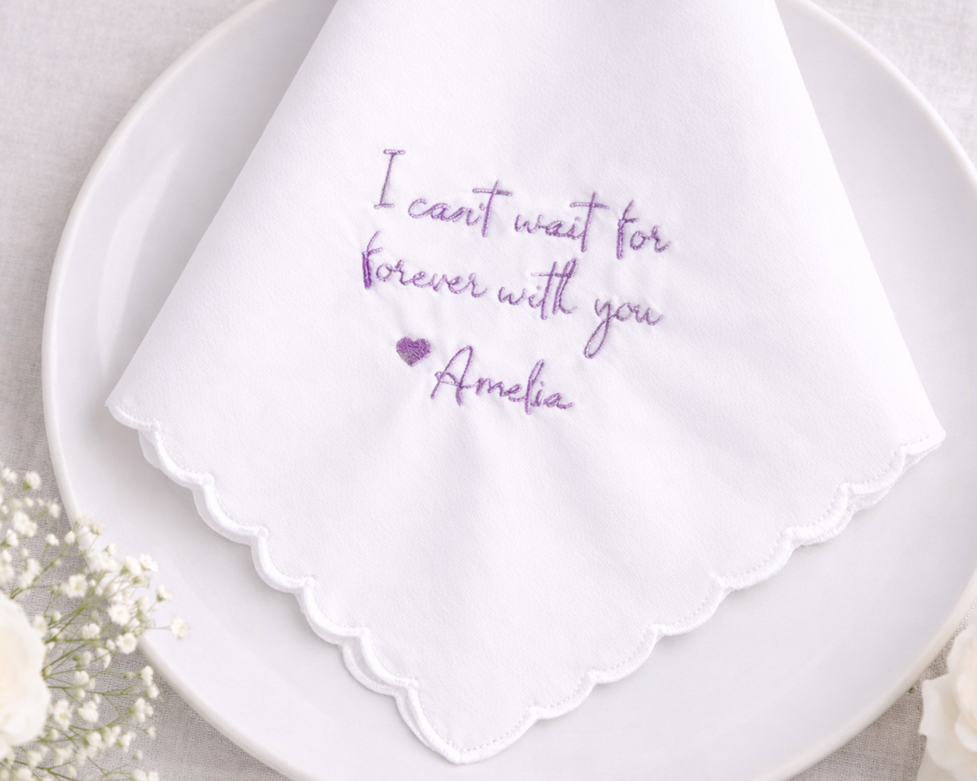 White handkerchief with purple text on a white plate