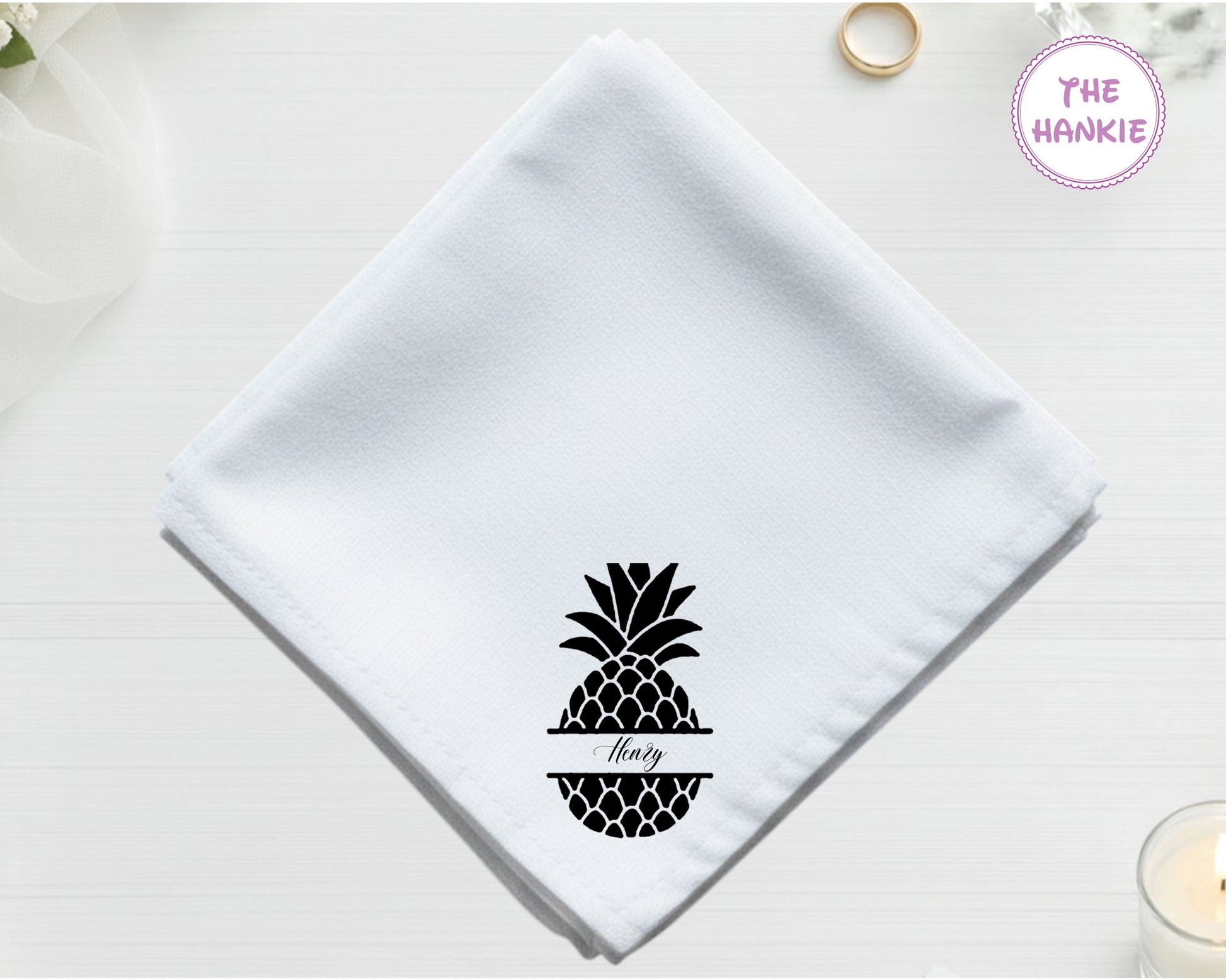 White hankie with black pineapple design and 'Flory' text on a light background.