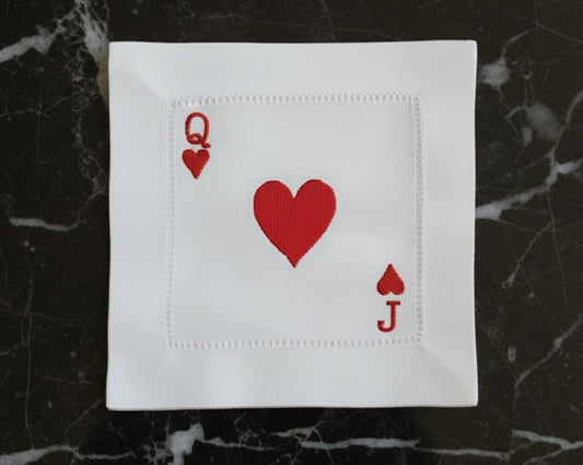 A single white cotton hemstitch napkin featuring a large center heart and "A" symbols for the Ace of Hearts in vibrant red machine embroidery.