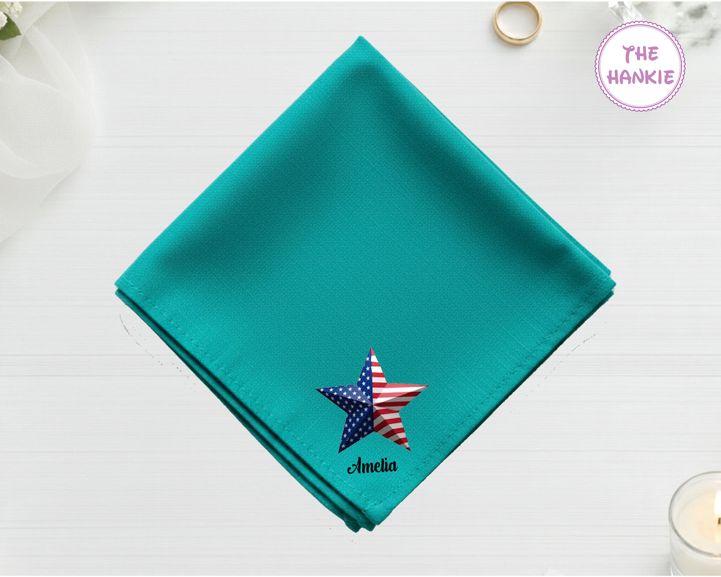 A vibrant seafoam teal cotton handkerchief featuring the name "Amelia" below a detailed 3D-effect American flag star illustration.