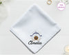 A crisp white cotton handkerchief personalized with "Amelia" below an indigo and gold Sagittarius bow and arrow icon.