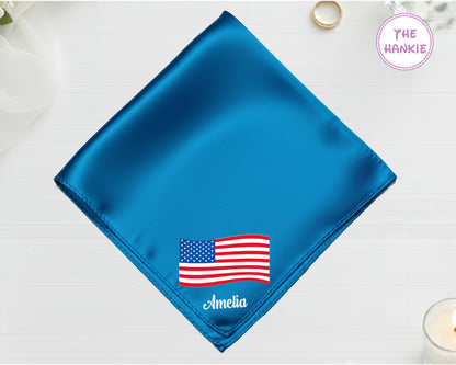 A brilliant sapphire blue satin handkerchief featuring "Amelia" and a detailed, waving American flag embroidery.