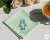 A soft mint green cotton handkerchief featuring the name "Ava" and a teal Wish Bear character with a shooting star embroidery.