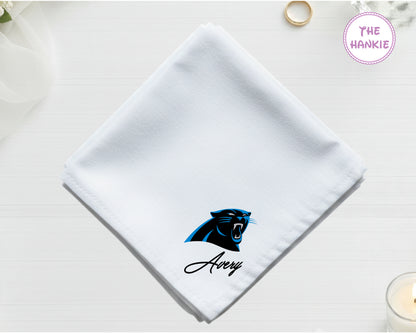A crisp white cotton handkerchief personalized with "Avery" below a high-definition blue and black Carolina Panthers NFL team icon vinyl print.