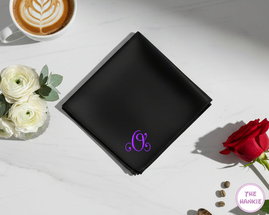 A black 100% cotton handkerchief featuring a vibrant purple embroidered initial "O" in an elegant script font.