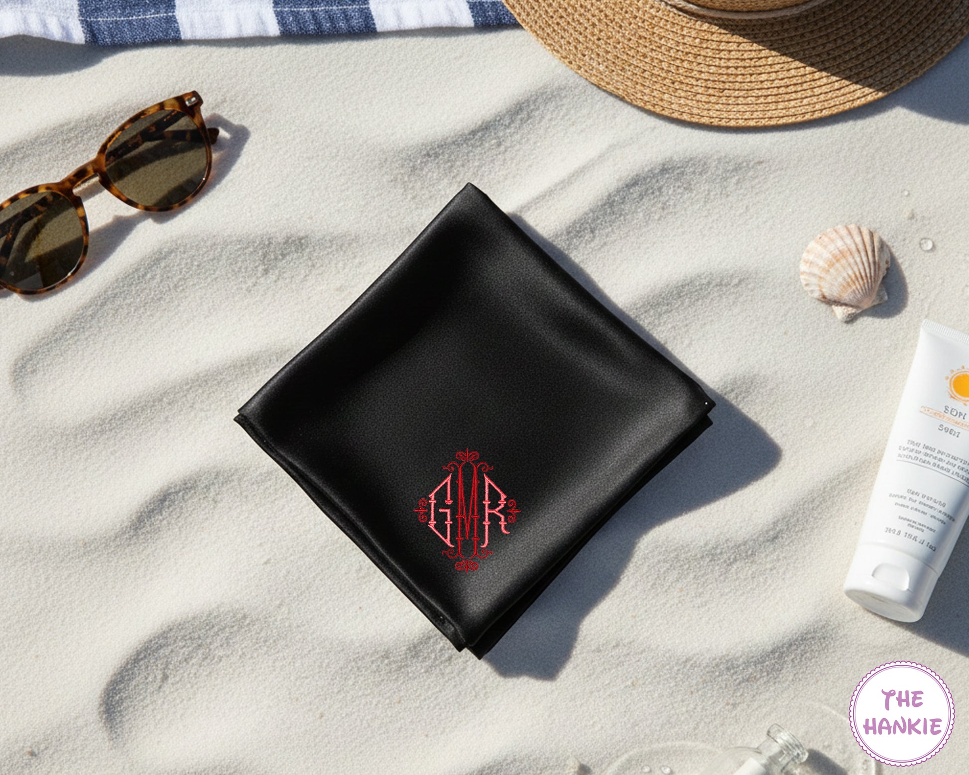 A luxury black satin handkerchief featuring a custom red embroidered diamond crest monogram with the initials "GMR".