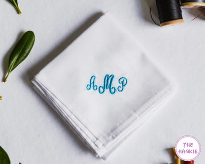 White cotton handkerchief embroidered with blue AMP script monogram