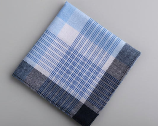 A folded light blue and slate grey windowpane check cotton handkerchief for men showing intricate weave patterns.