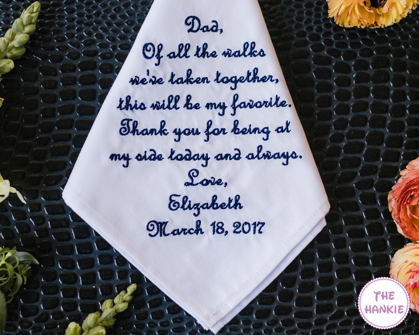 Bride holding personalized wedding handkerchief for father with emotional embroidered message