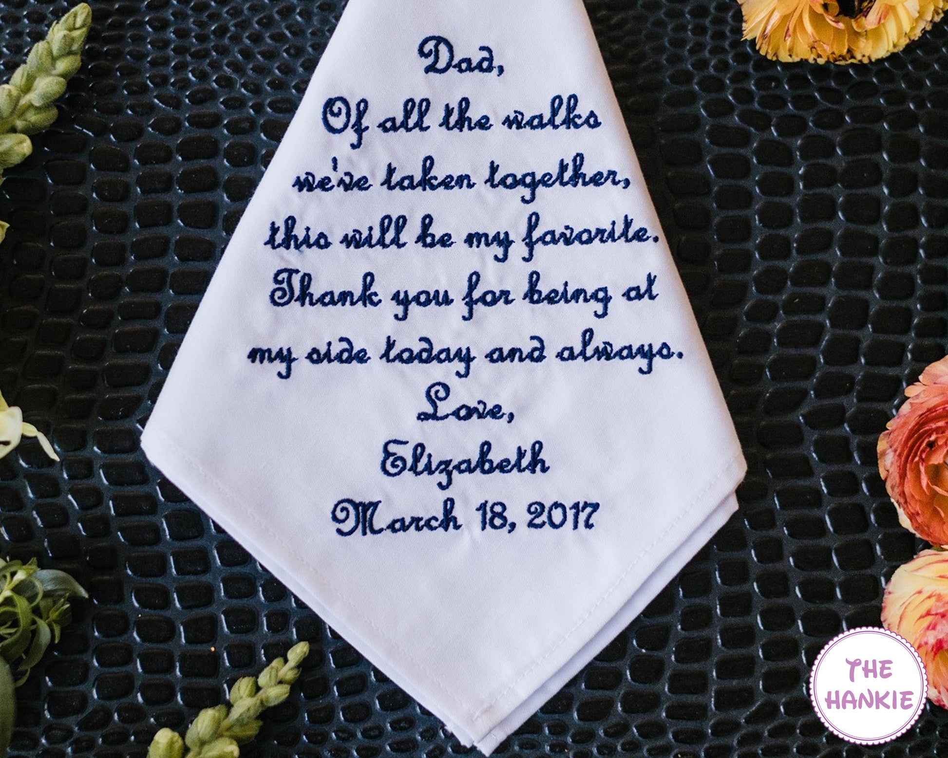 Bride holding personalized wedding handkerchief for father with emotional embroidered message