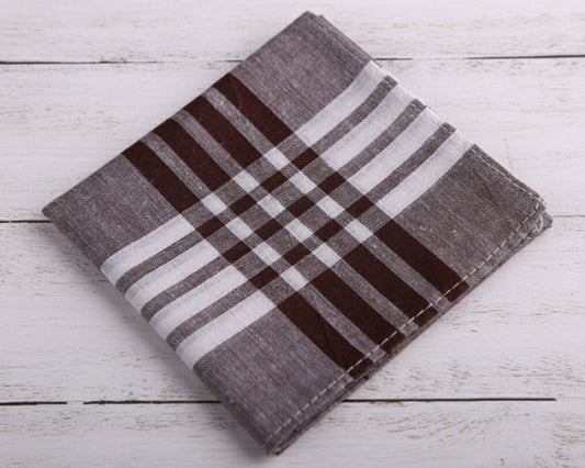 A premium mahogany brown and white tartan checkered cotton handkerchief displayed flat on a white wooden background.