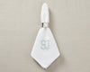 White cotton napkin with classic embroidered monogram initials for luxury table setting