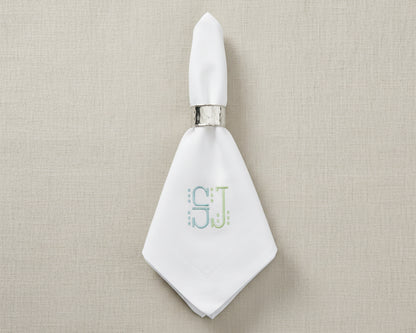 White cotton napkin with classic embroidered monogram initials for luxury table setting