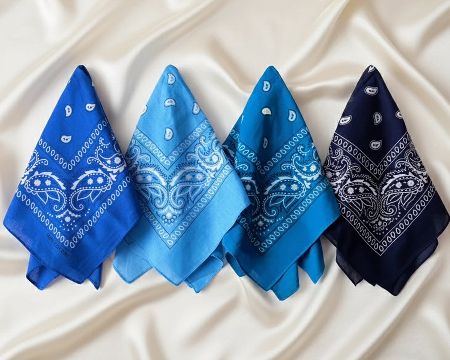 A light blue paisley bandana featuring a personalized name "Leo" in white chain stitch embroidery.