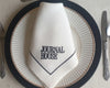 Napkin with 'Journal House' logo on a plate with cutlery