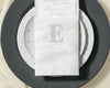 Custom embroidered cotton napkin with classic letter E monogram on elegant table setting