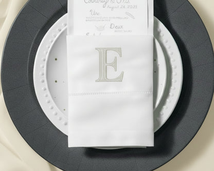 Custom embroidered cotton napkin with classic letter E monogram on elegant table setting
