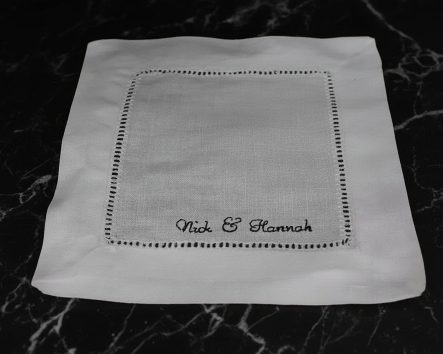 A design guide illustrating five different embroidery placement options for personalized linen napkins, including left, center, right, middle, and corner.