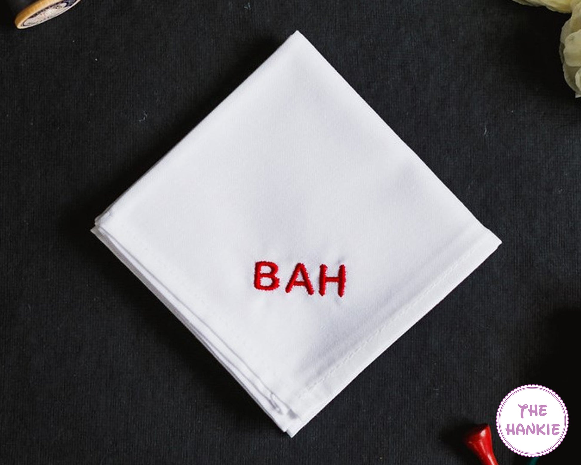 White cotton handkerchief with bold red embroidered name monogram