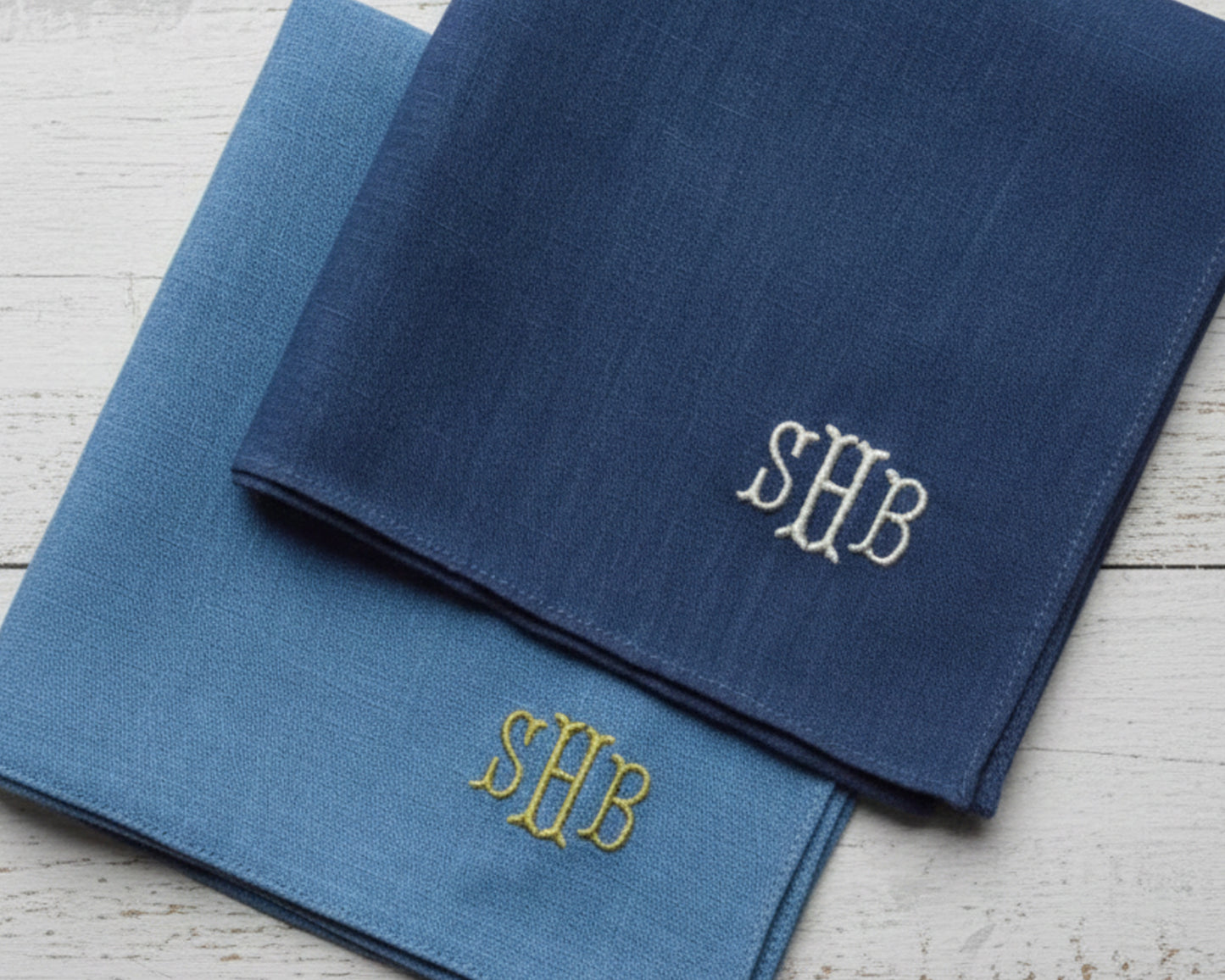 Two 100% premium cotton pocket squares in crisp white and deep navy, featuring custom three-letter "SHB" monogram embroidery in a classic serif font.