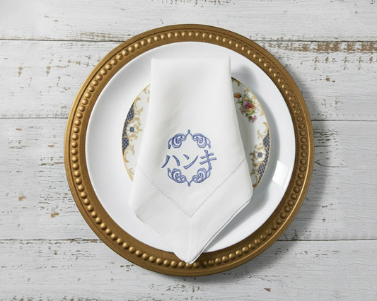 Custom monogrammed white linen napkin with embroidered initials, perfect for weddings and fine dining