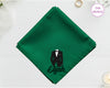 A lush forest green cotton pocket square featuring the name "Elijah" below a detailed black and white vinyl print of a formal tuxedo suit.