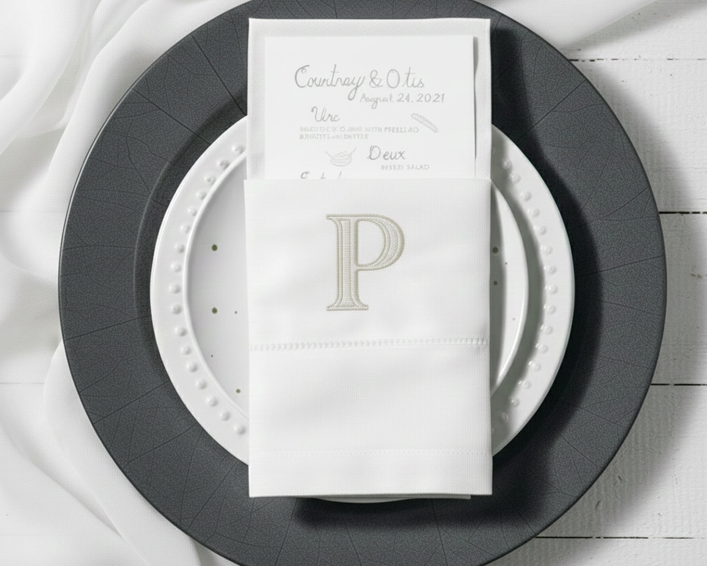 Embroidered cotton napkin with classic P monogram used as elegant table napkin holder