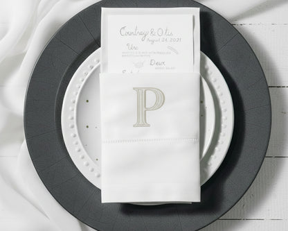 Embroidered cotton napkin with classic P monogram used as elegant table napkin holder