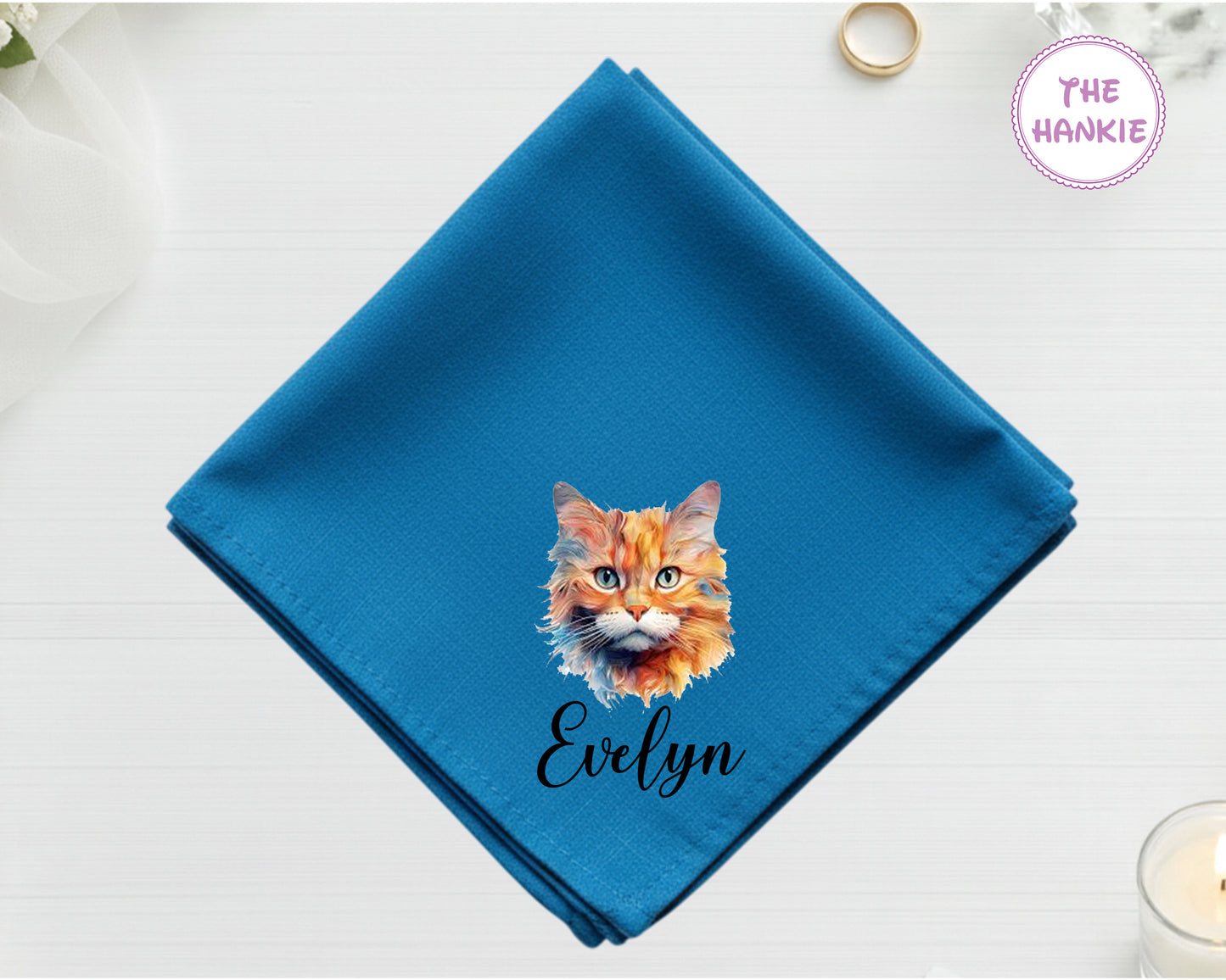A brilliant sapphire blue high-lustre satin pocket square customized with the name "Evelyn" and a painterly, orange-and-white cat portrait.