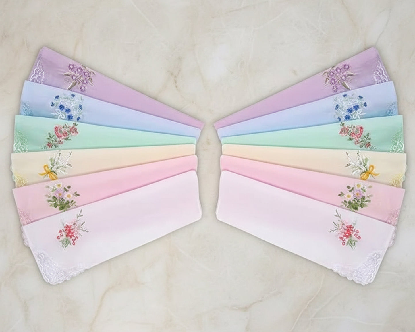A fan-shaped display of 12 pastel-colored cotton handkerchiefs with floral embroidery