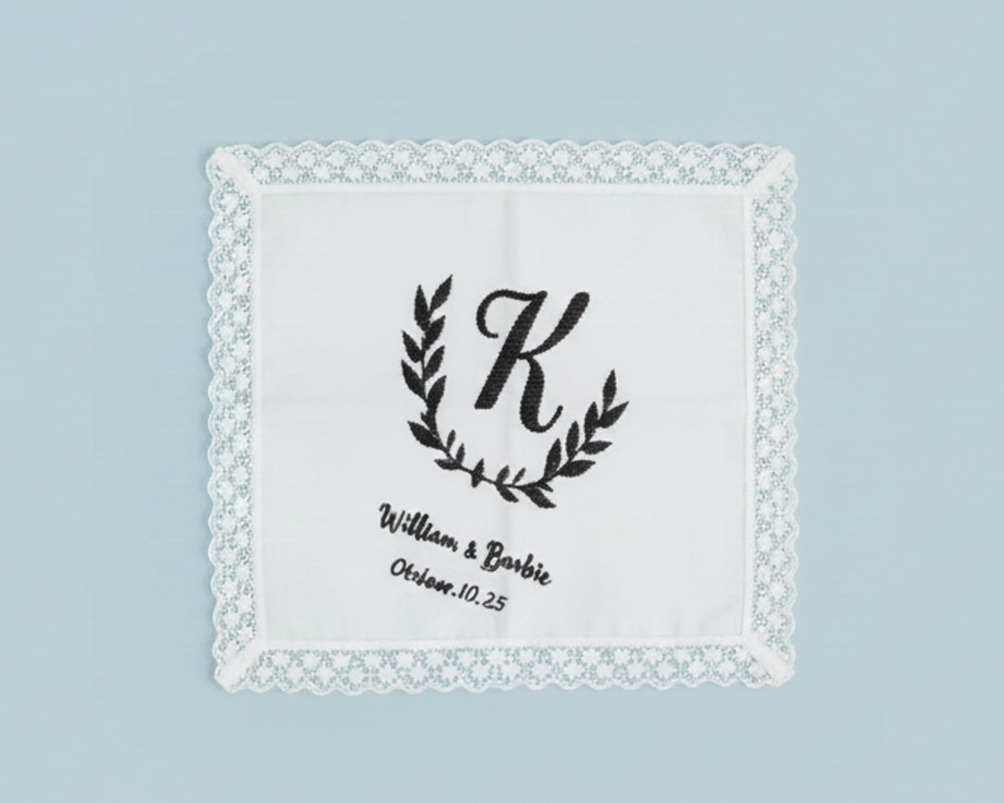 White cotton guest hand towel with a classic three-letter monogram in French Blue thread and hemstitch detail