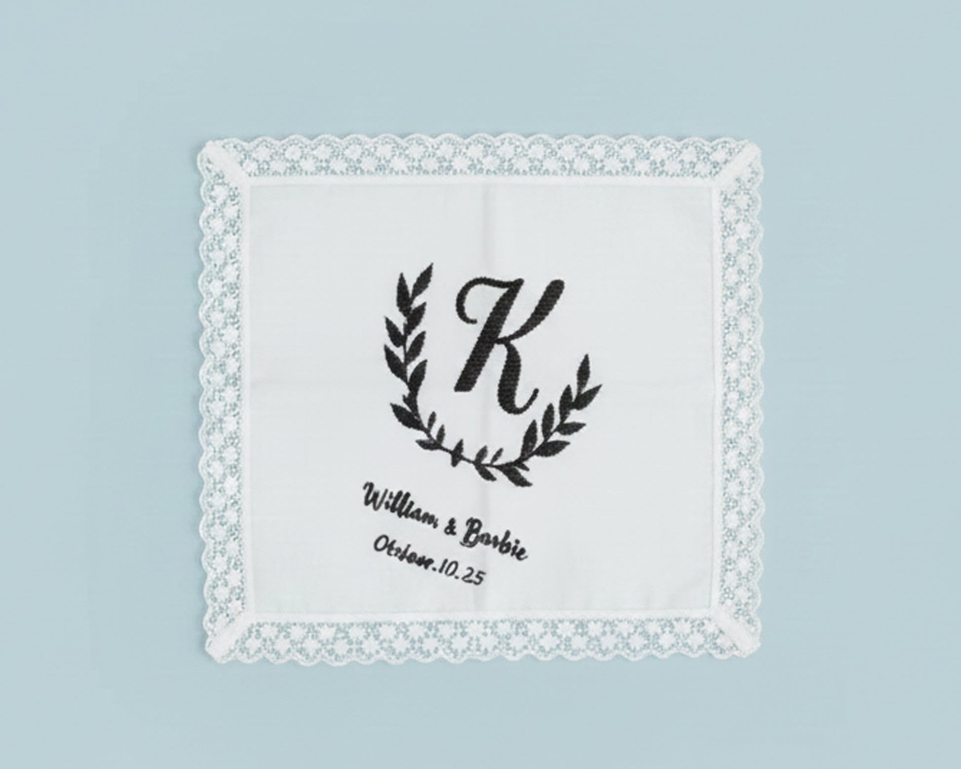 White cotton guest hand towel with a classic three-letter monogram in French Blue thread and hemstitch detail