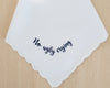 A personalized white wedding handkerchief with a scalloped border, featuring a humorous navy blue embroidered message that says "No ugly crying".
