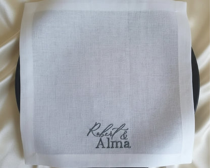 White handkerchief with 'Robert & Alma' embroidery on a white background