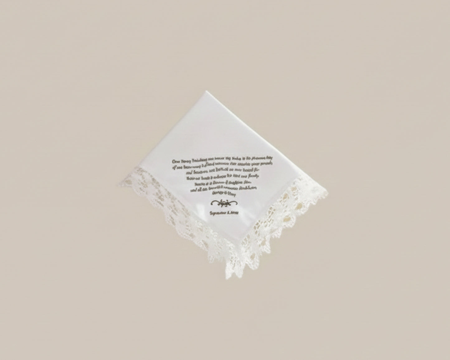 Bespoke white napkin featuring a green heraldic shield crest with a lion, mountain motif, and R initial