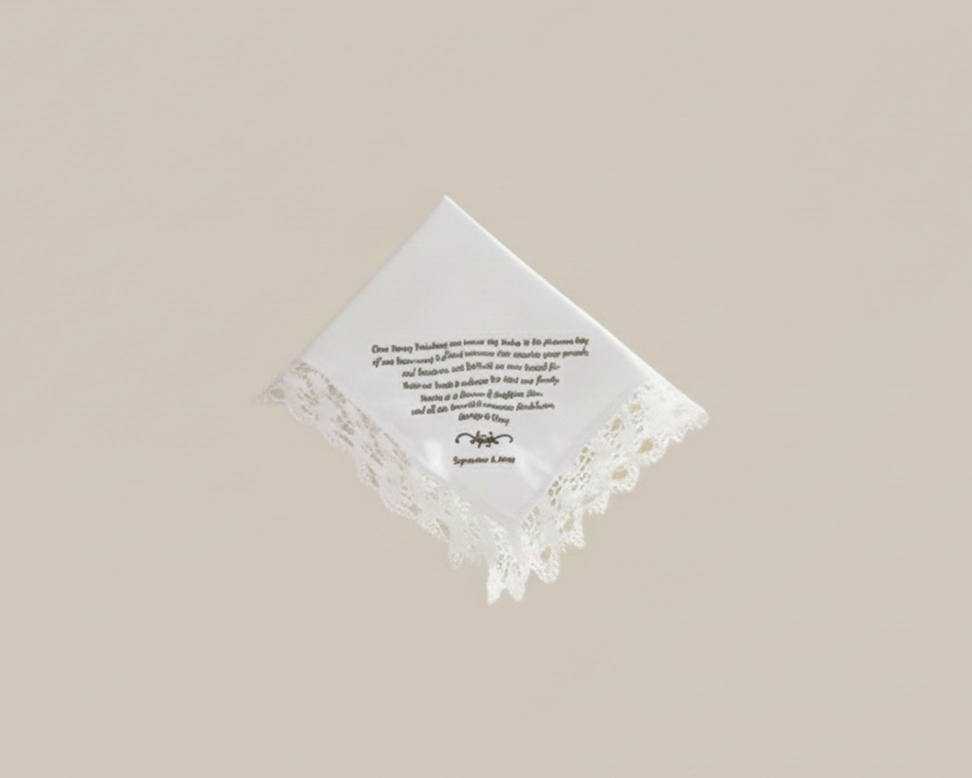 Bespoke white napkin featuring a green heraldic shield crest with a lion, mountain motif, and R initial