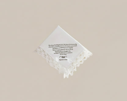 Bespoke white napkin featuring a green heraldic shield crest with a lion, mountain motif, and R initial