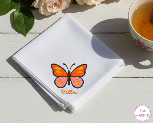 A sky blue premium cotton handkerchief customized with the name "Isabella" and a detailed brown and tan stag beetle embroidery.