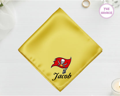 A radiant gold high-lustre satin handkerchief personalized with the name "Jacob" below a high-definition vinyl Tampa Bay Buccaneers team icon.